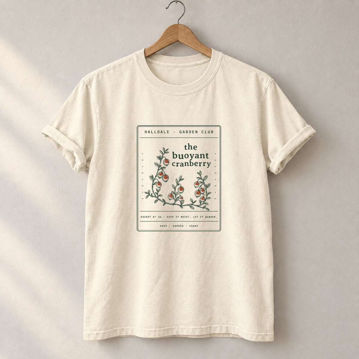 The Buoyant Cranberry tee in Ivory, on a hanger