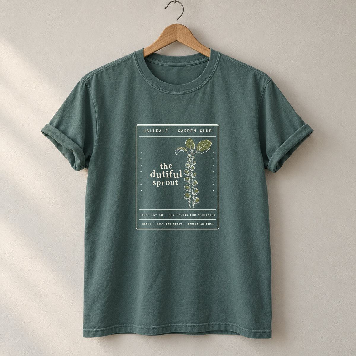 The Dutiful Sprout tee in Blue Spruce, on a hanger