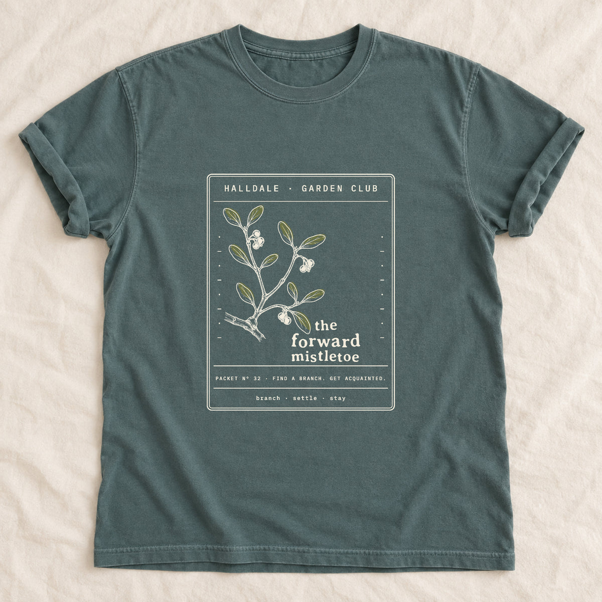 The Forward Mistletoe tee in Blue Spruce, laid flat