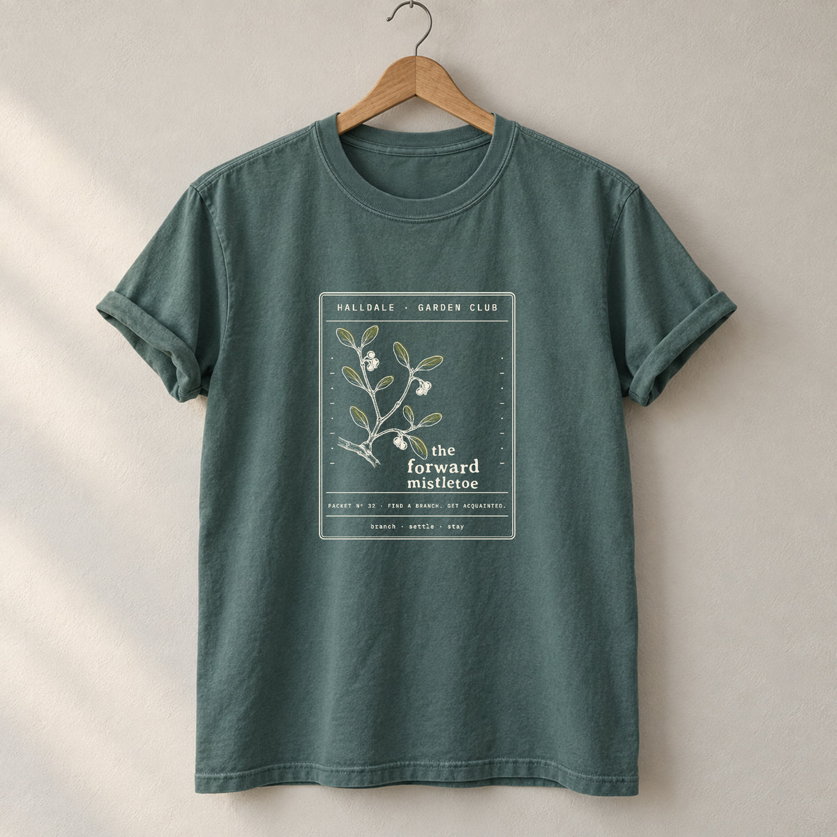 The Forward Mistletoe tee in Blue Spruce, on a hanger