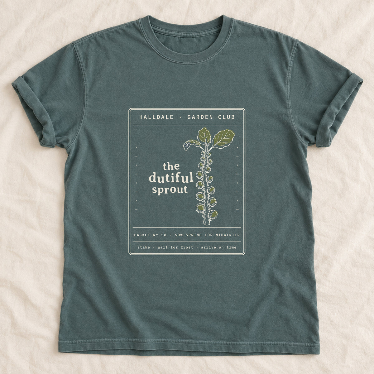 The Dutiful Sprout tee in Blue Spruce, laid flat