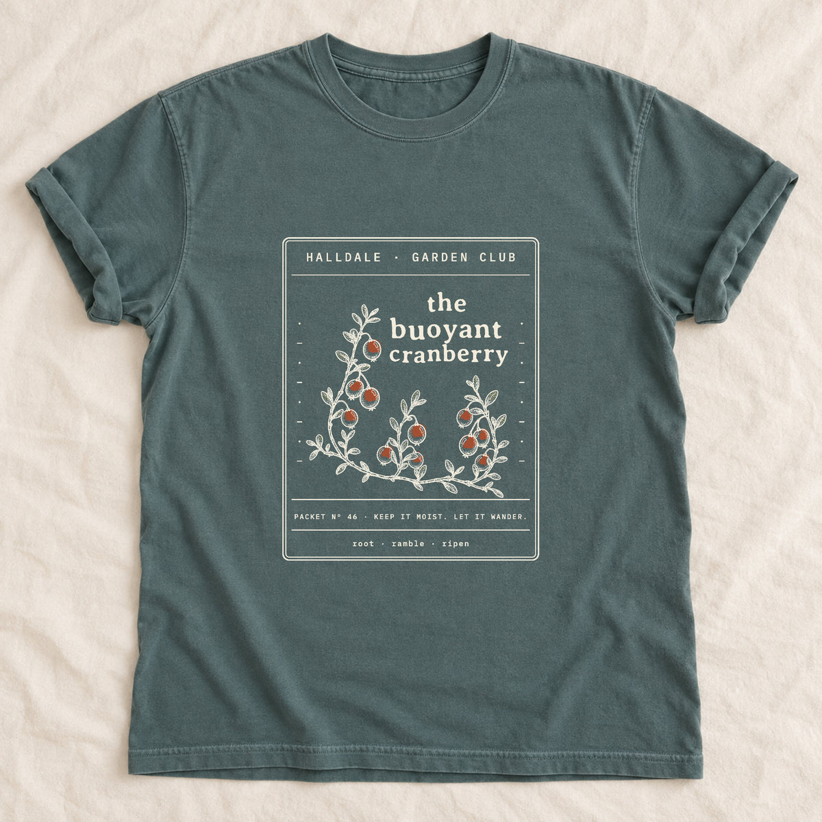 The Buoyant Cranberry tee in Blue Spruce, laid flat