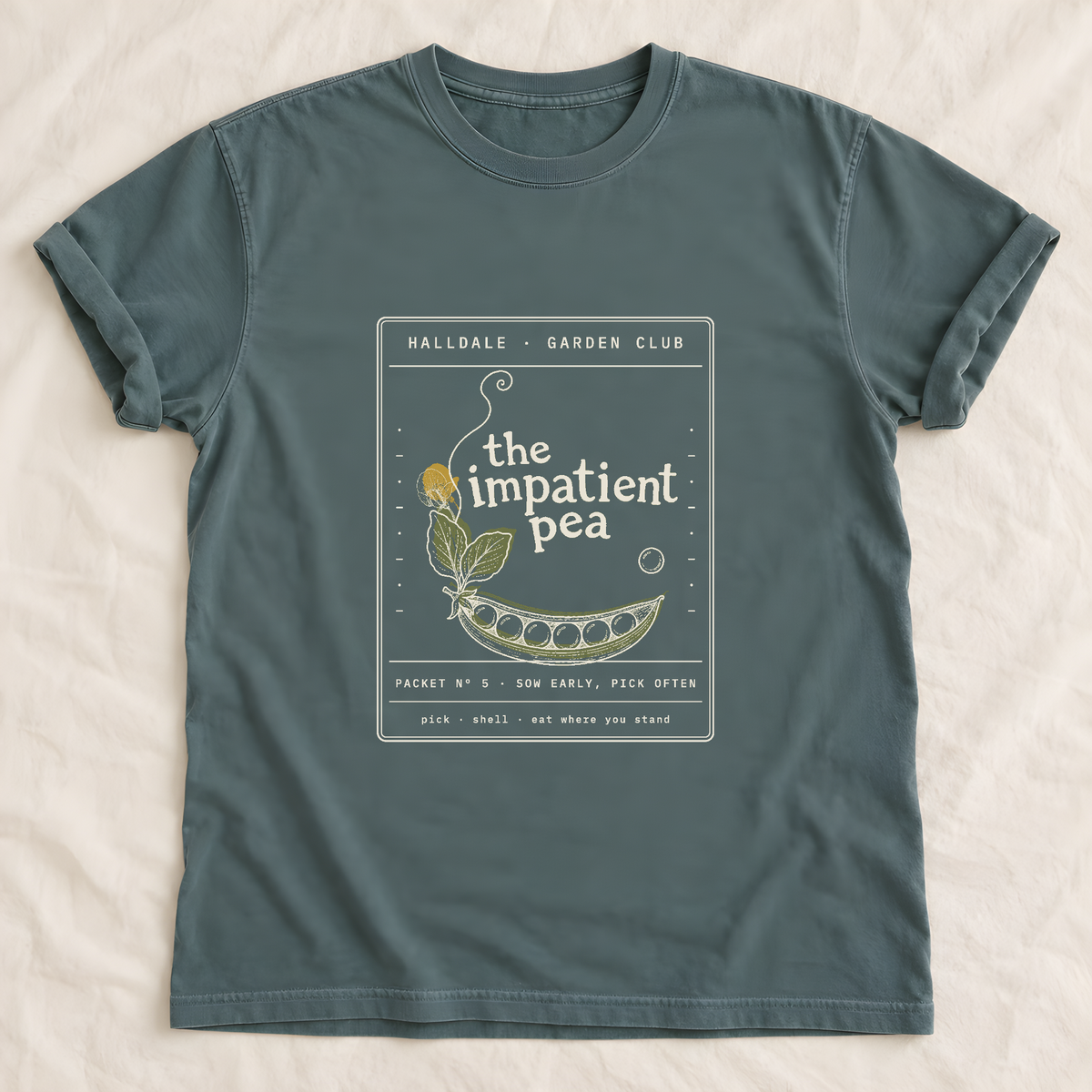 The Impatient Pea tee in Blue Spruce, laid flat