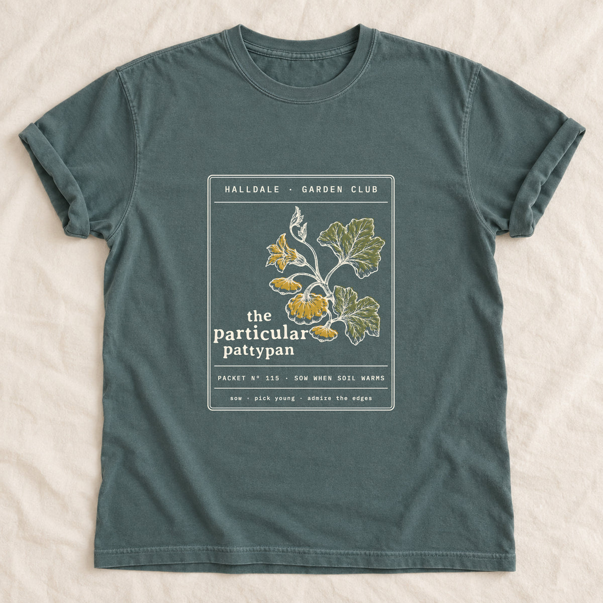 The Particular Pattypan tee in Blue Spruce, laid flat