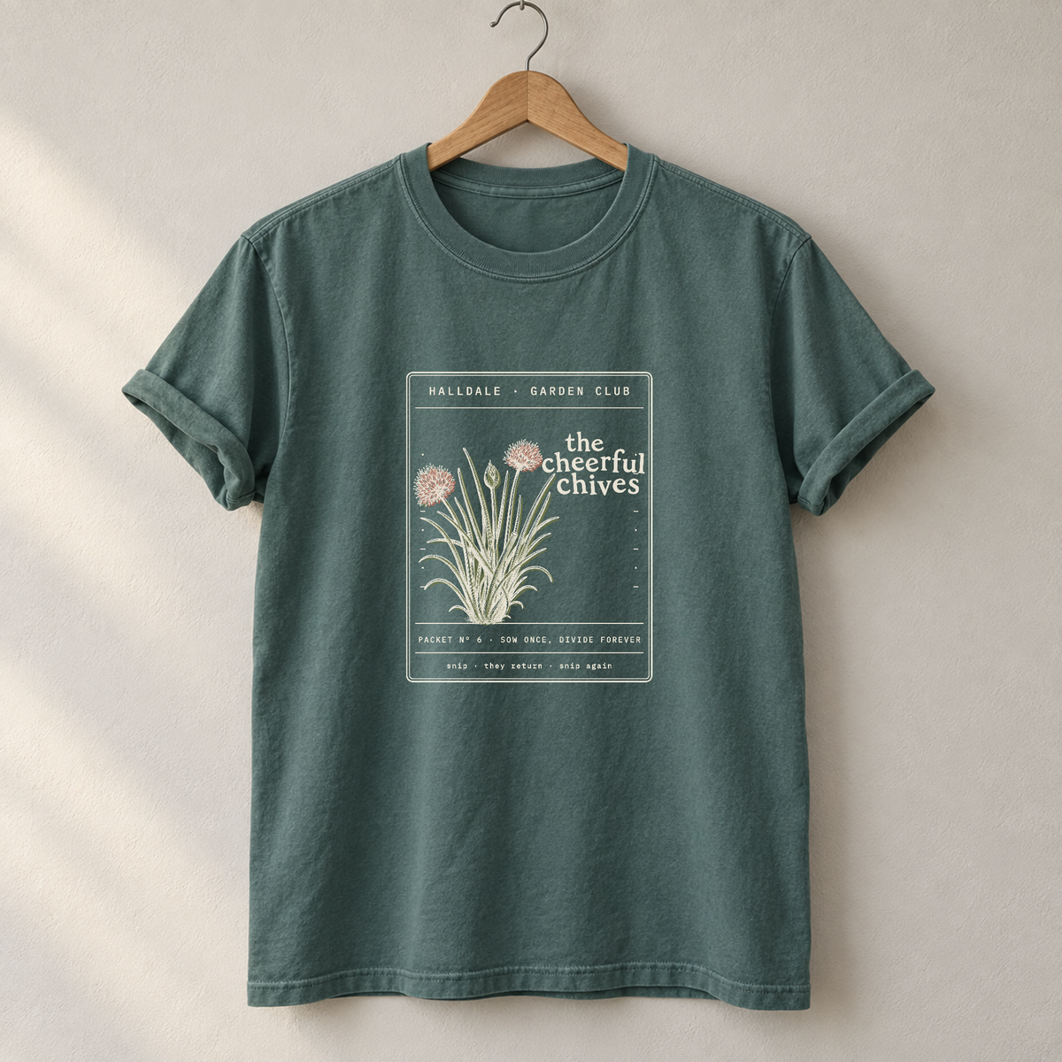 The Cheerful Chives tee in Blue Spruce, on a hanger