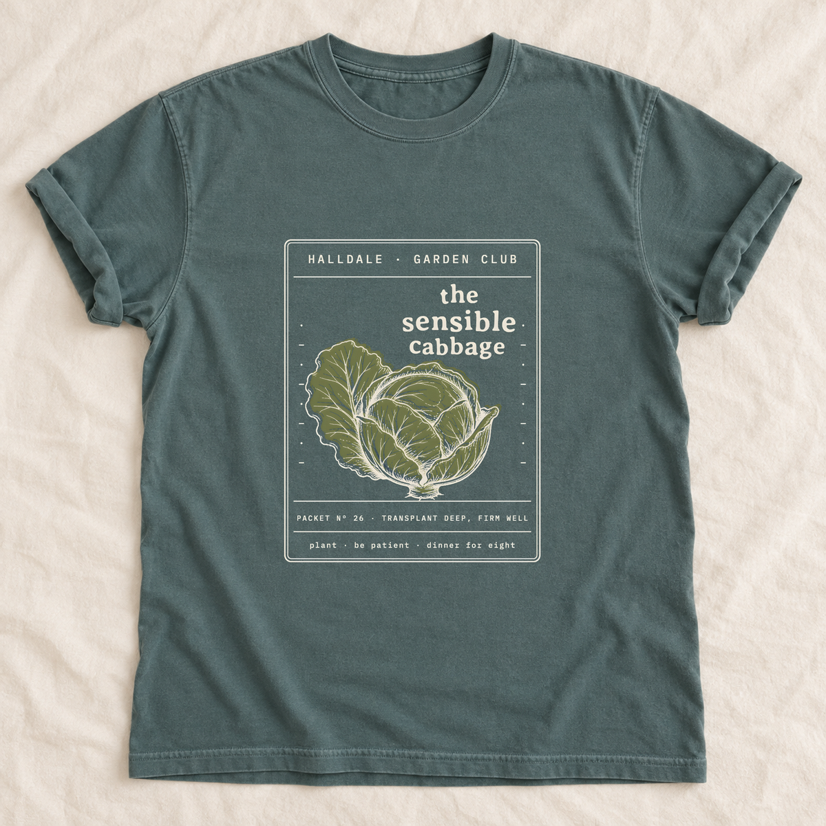 The Sensible Cabbage tee in Blue Spruce, laid flat