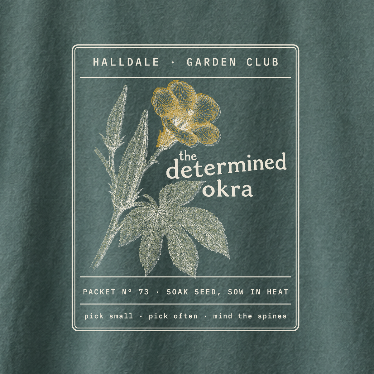 The Determined Okra tee in Blue Spruce, close-up of the print