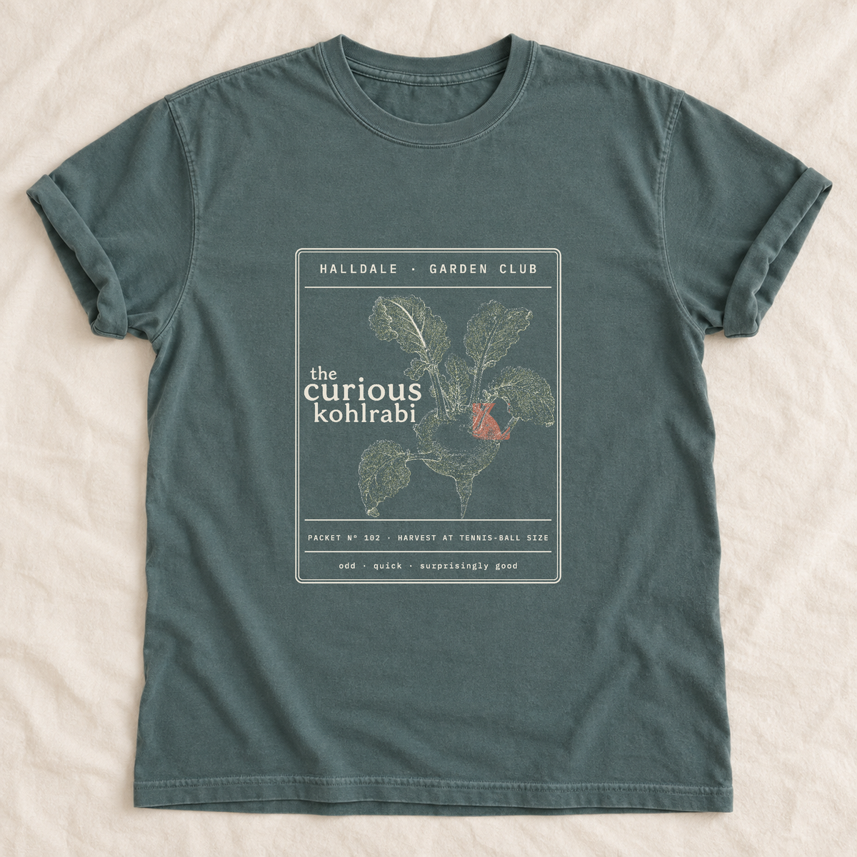 The Curious Kohlrabi tee in Blue Spruce, laid flat