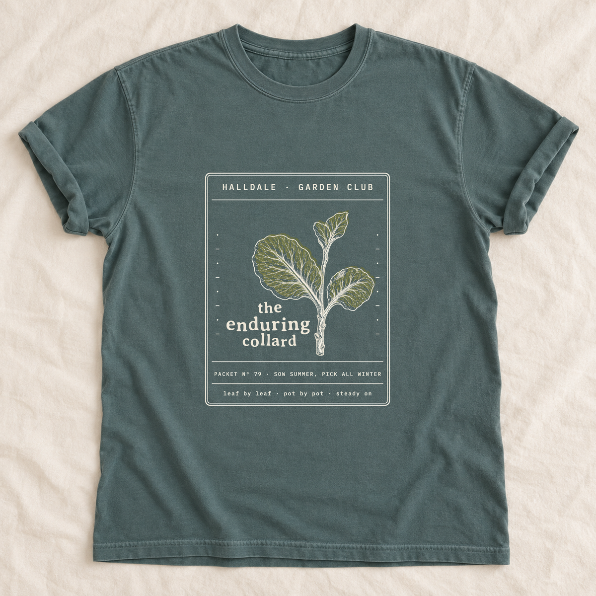 The Enduring Collard tee in Blue Spruce, laid flat