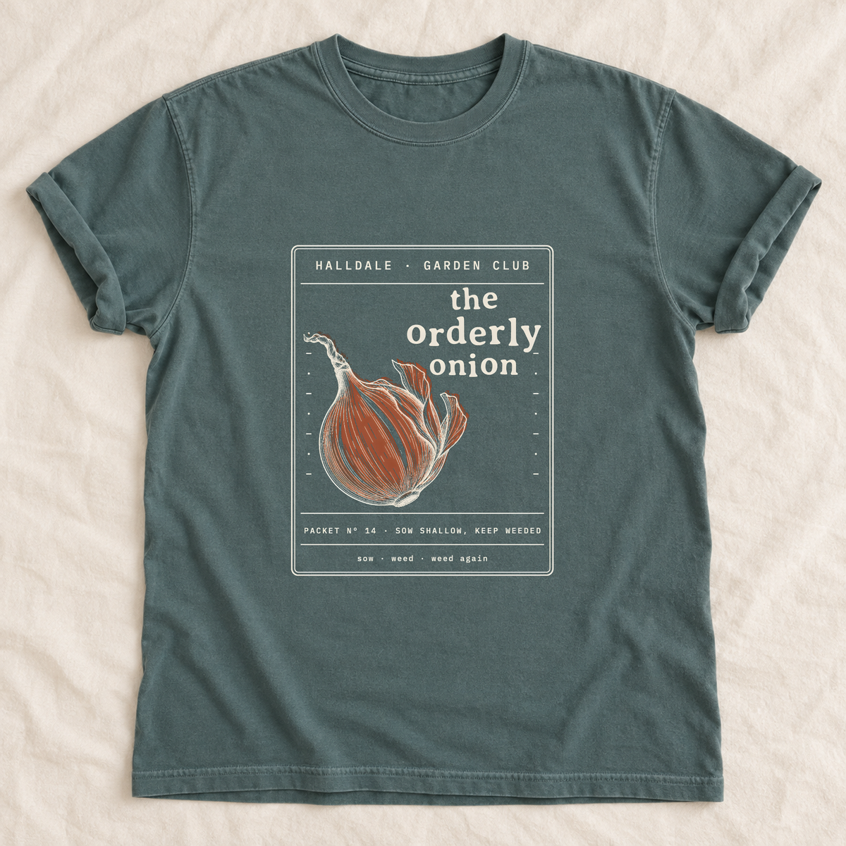 The Orderly Onion tee in Blue Spruce, laid flat