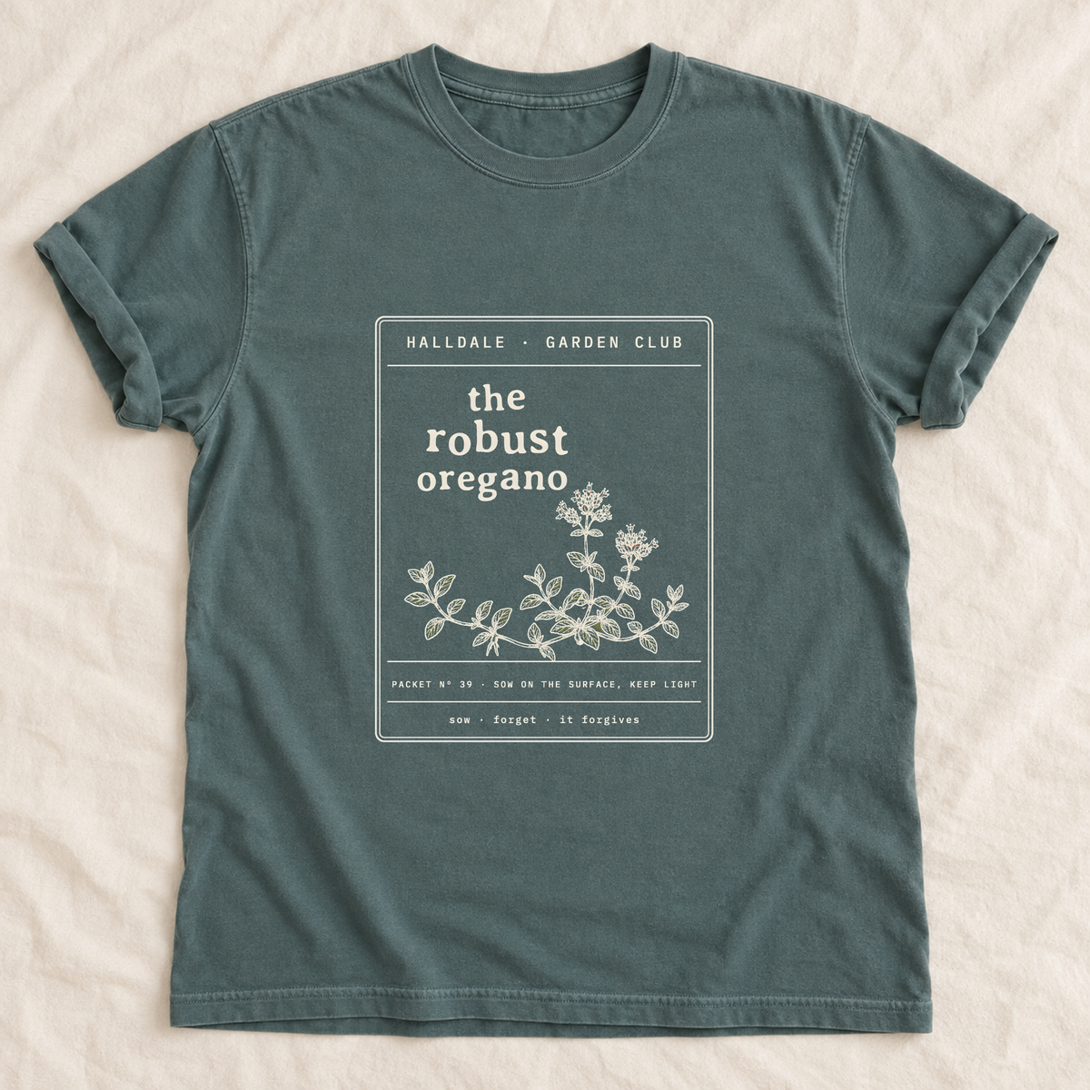 The Robust Oregano tee in Blue Spruce, laid flat
