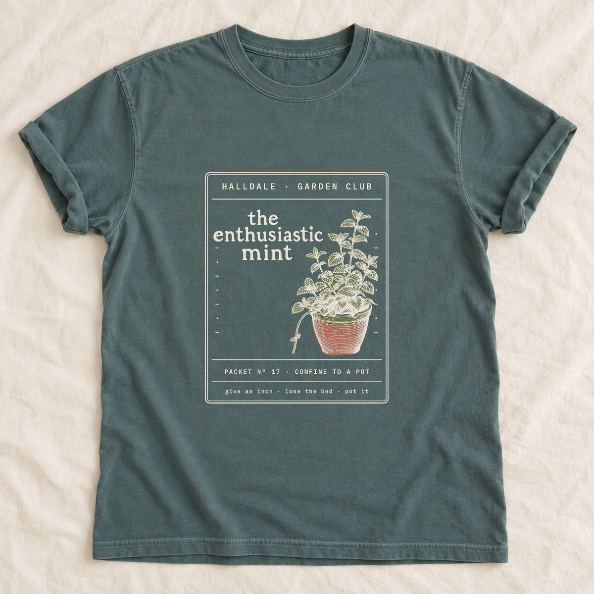 The Enthusiastic Mint tee in Blue Spruce, laid flat