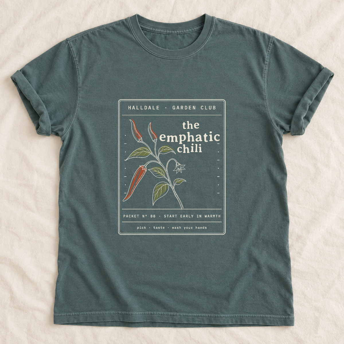The Emphatic Chili tee in Blue Spruce, laid flat