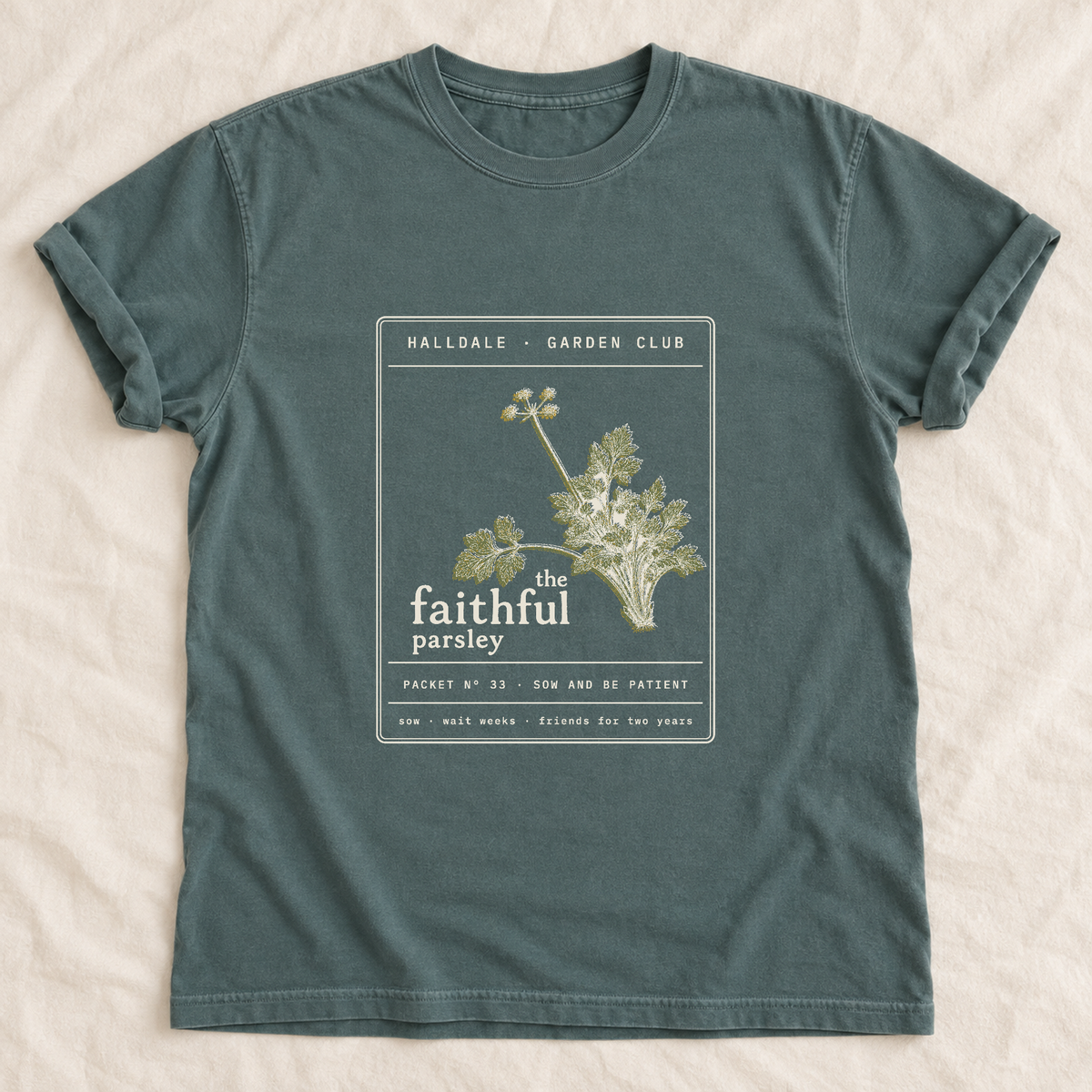 The Faithful Parsley tee in Blue Spruce, laid flat