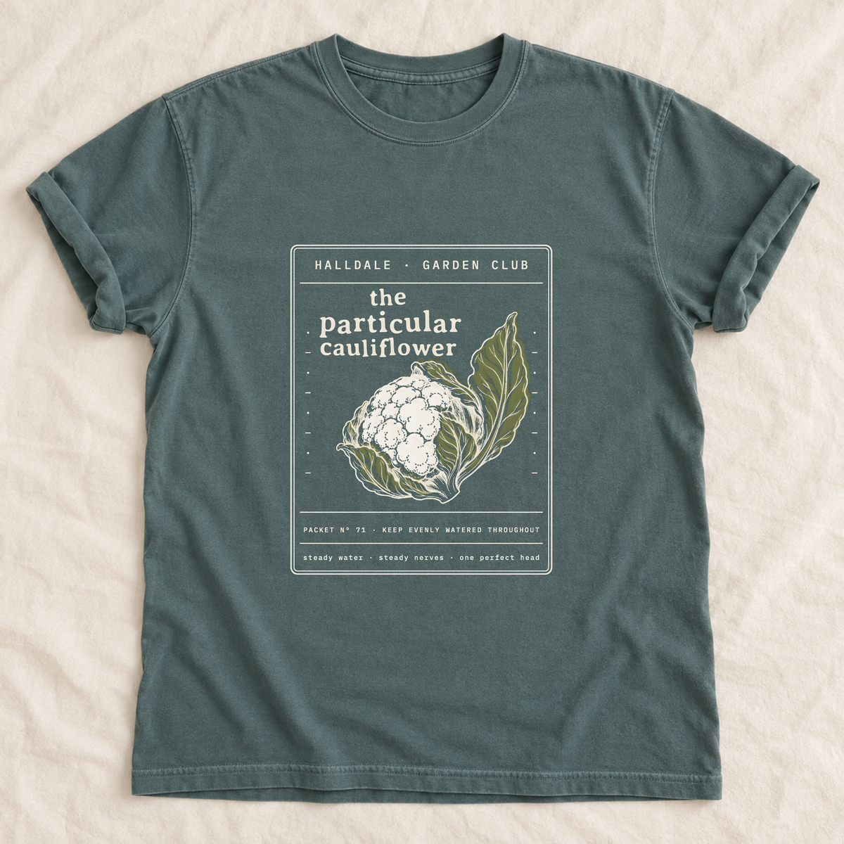 The Particular Cauliflower tee in Blue Spruce, laid flat