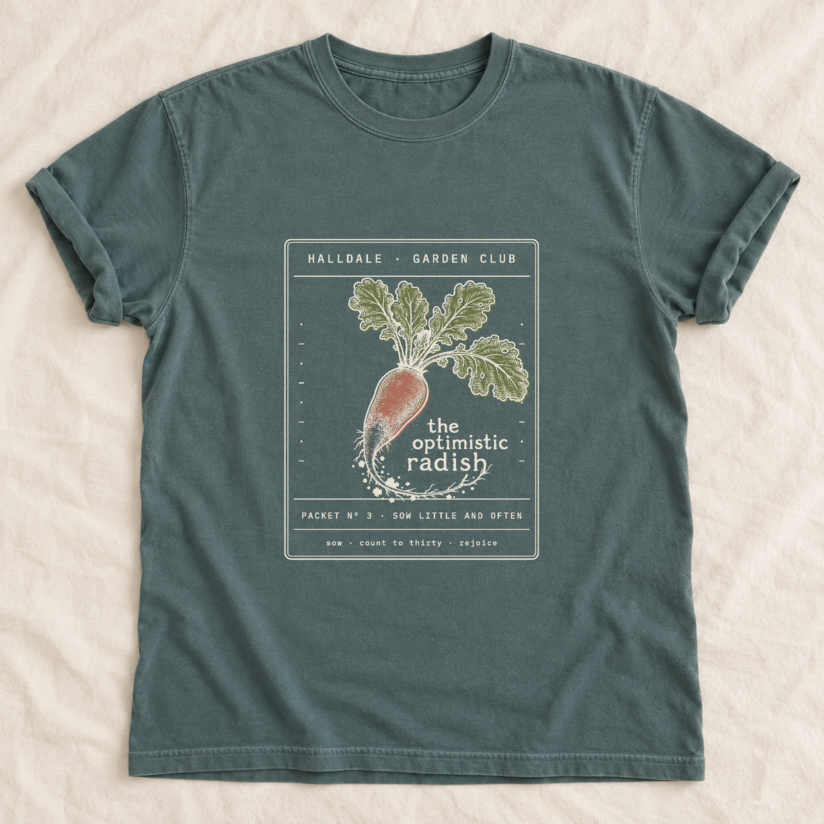 The Optimistic Radish tee in Blue Spruce, laid flat