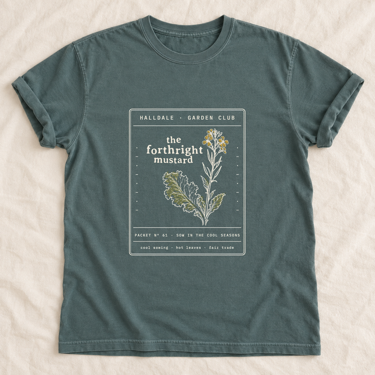 The Forthright Mustard tee in Blue Spruce, laid flat