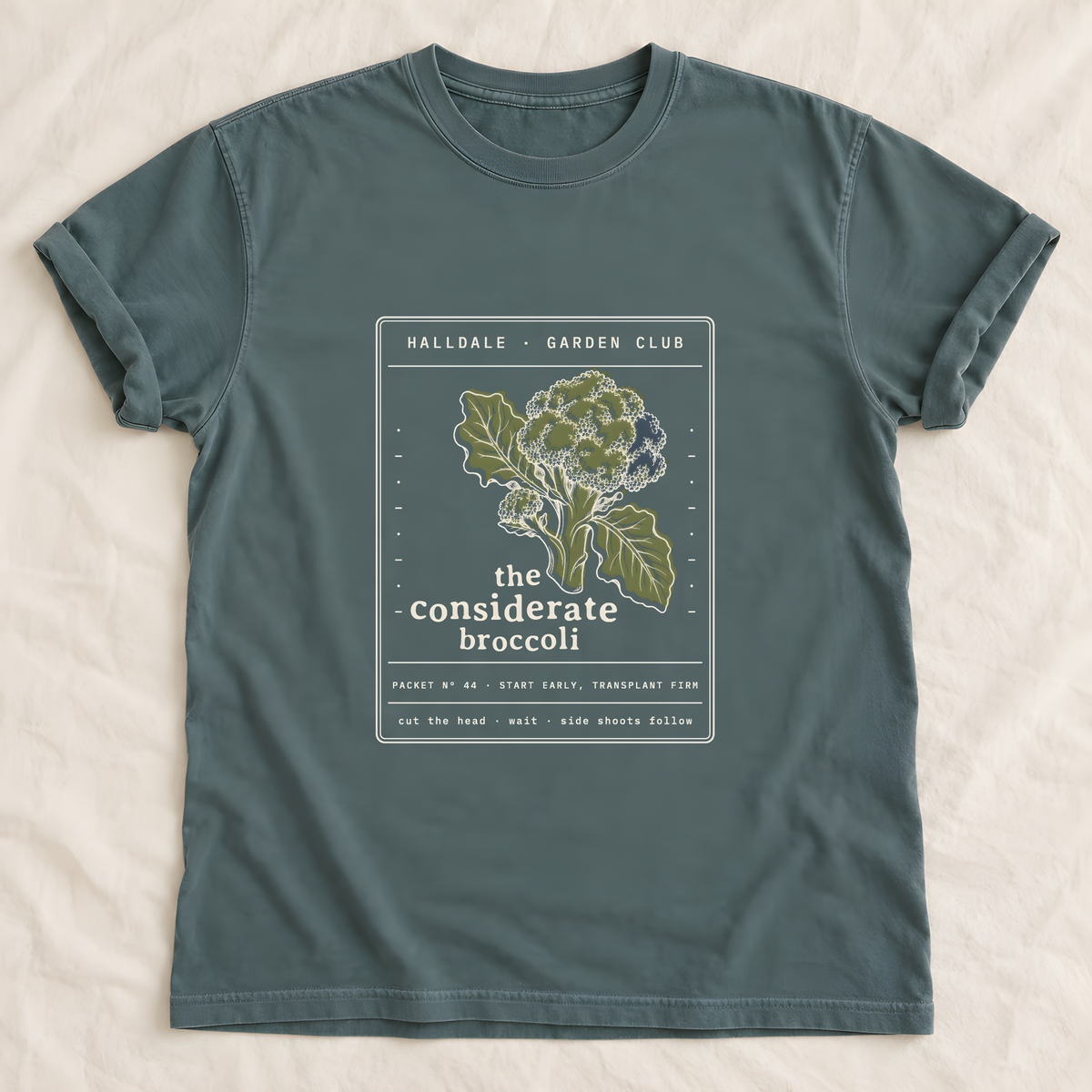 The Considerate Broccoli tee in Blue Spruce, laid flat
