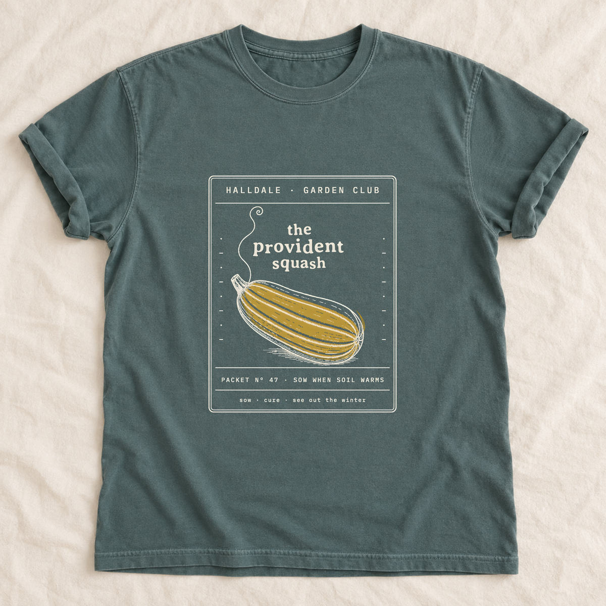 The Provident Squash tee in Blue Spruce, laid flat