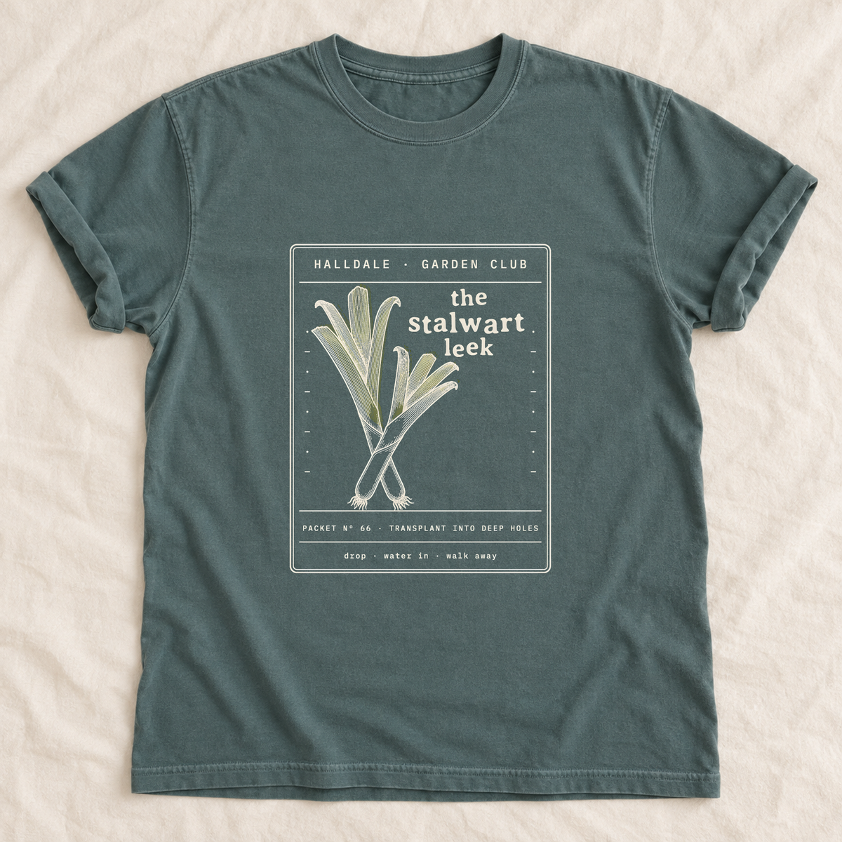 The Stalwart Leek tee in Blue Spruce, laid flat