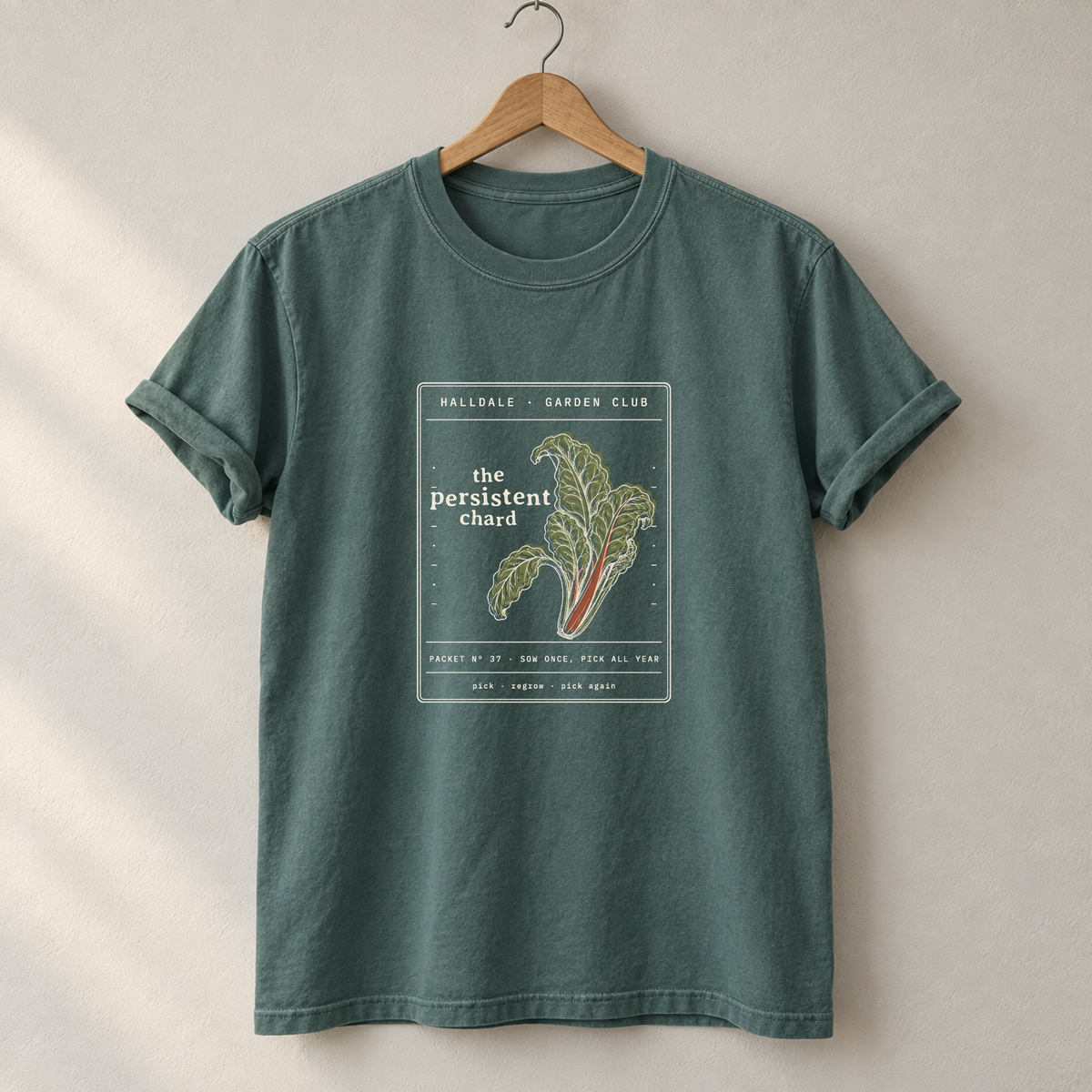 The Persistent Chard tee in Blue Spruce, on a hanger