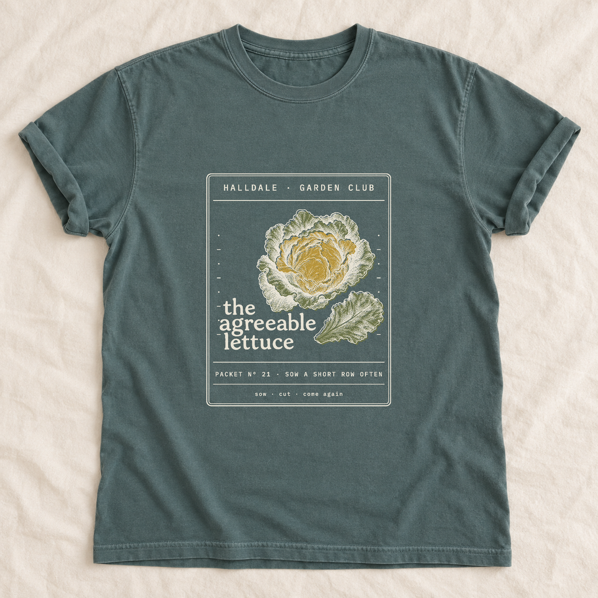 The Agreeable Lettuce tee in Blue Spruce, laid flat