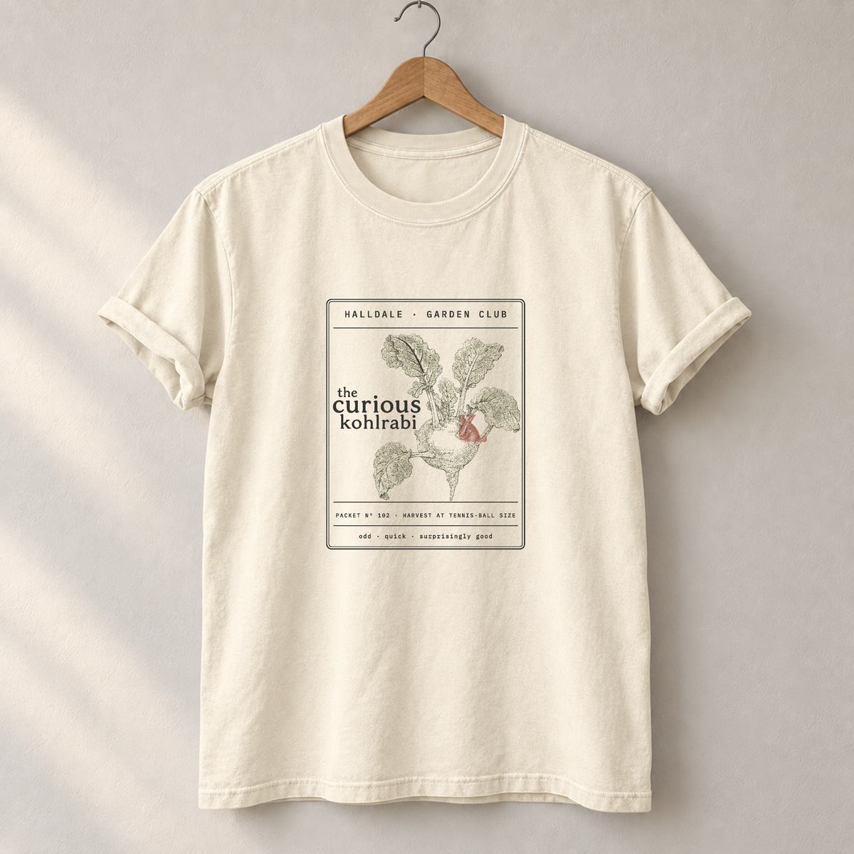 The Curious Kohlrabi tee in Ivory, on a hanger