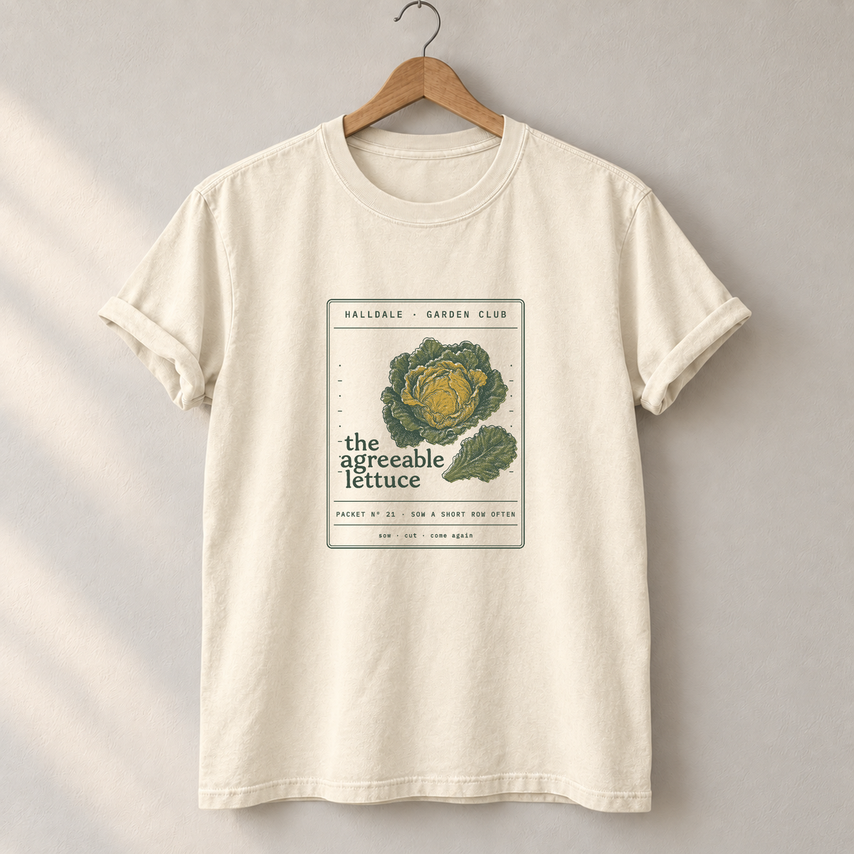 The Agreeable Lettuce tee in Ivory, on a hanger