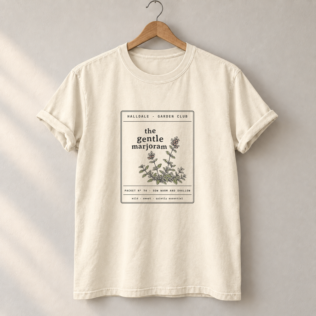 The Gentle Marjoram tee in Ivory, on a hanger