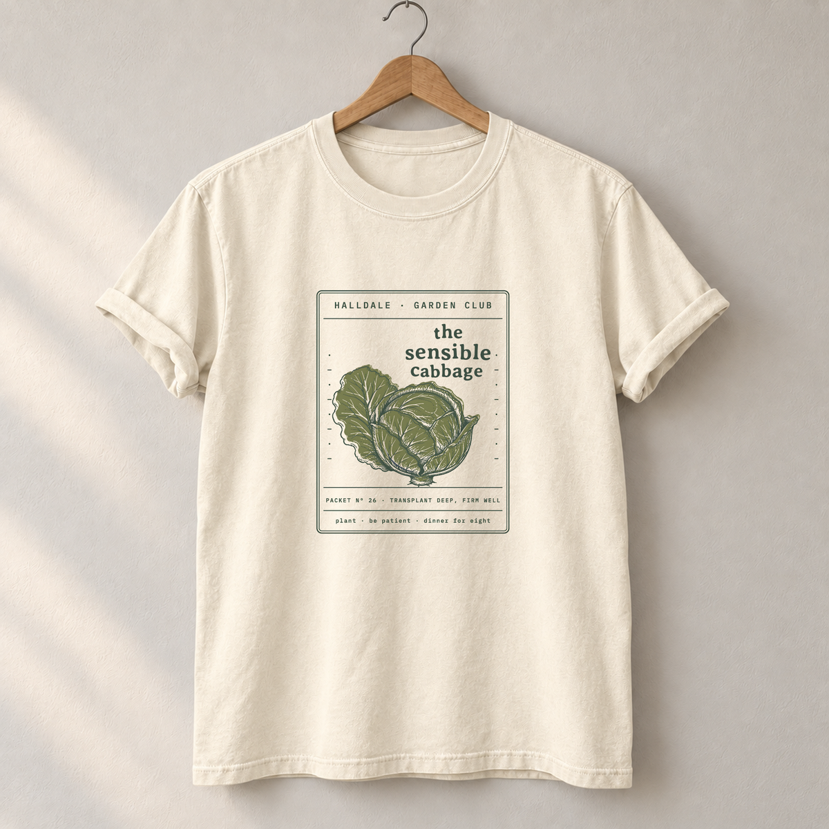 The Sensible Cabbage tee in Ivory, on a hanger