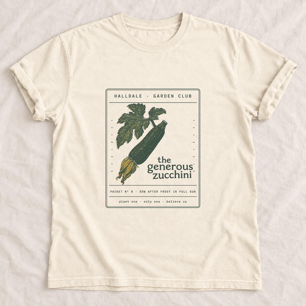 The Generous Zucchini tee in Ivory, laid flat