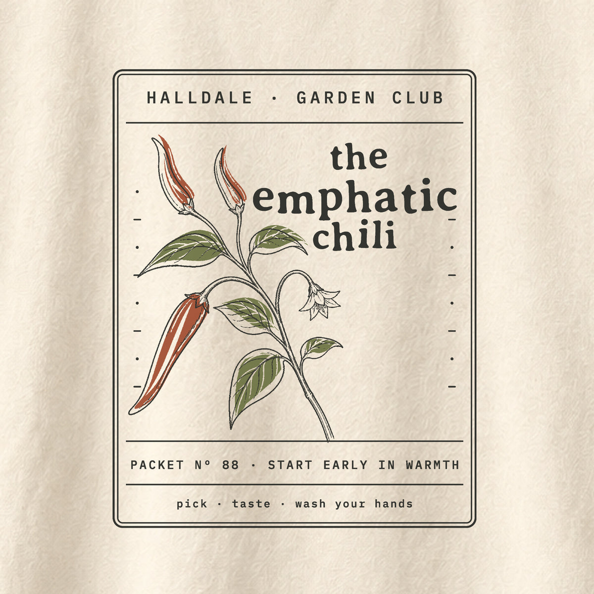 The Emphatic Chili tee in Ivory, close-up of the print