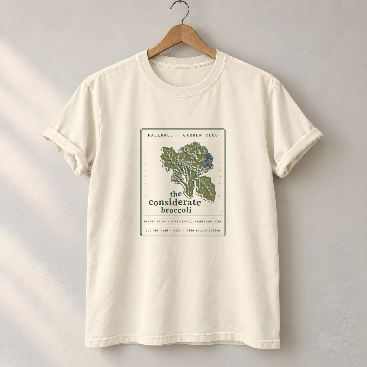 The Considerate Broccoli tee in Ivory, on a hanger