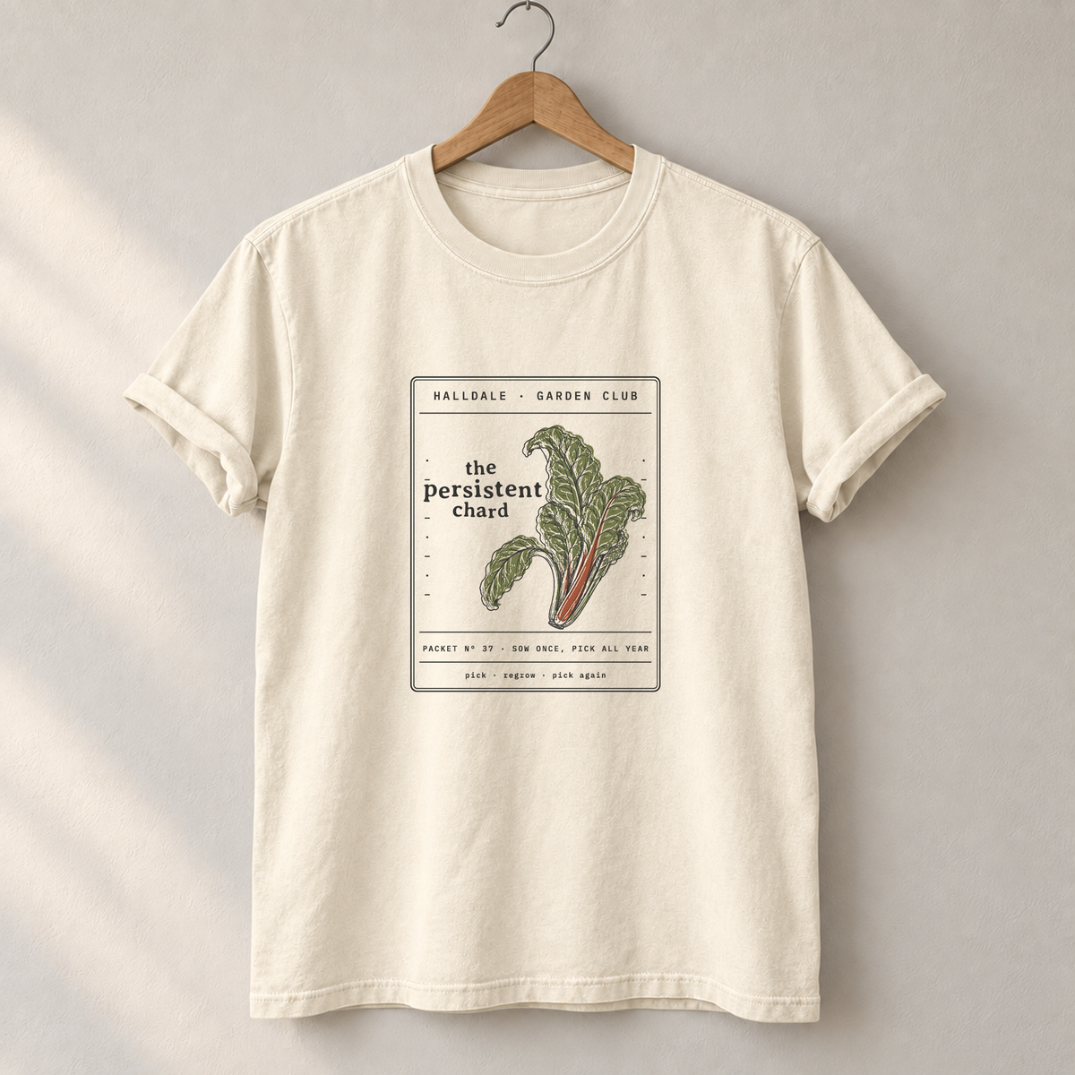 The Persistent Chard tee in Ivory, on a hanger