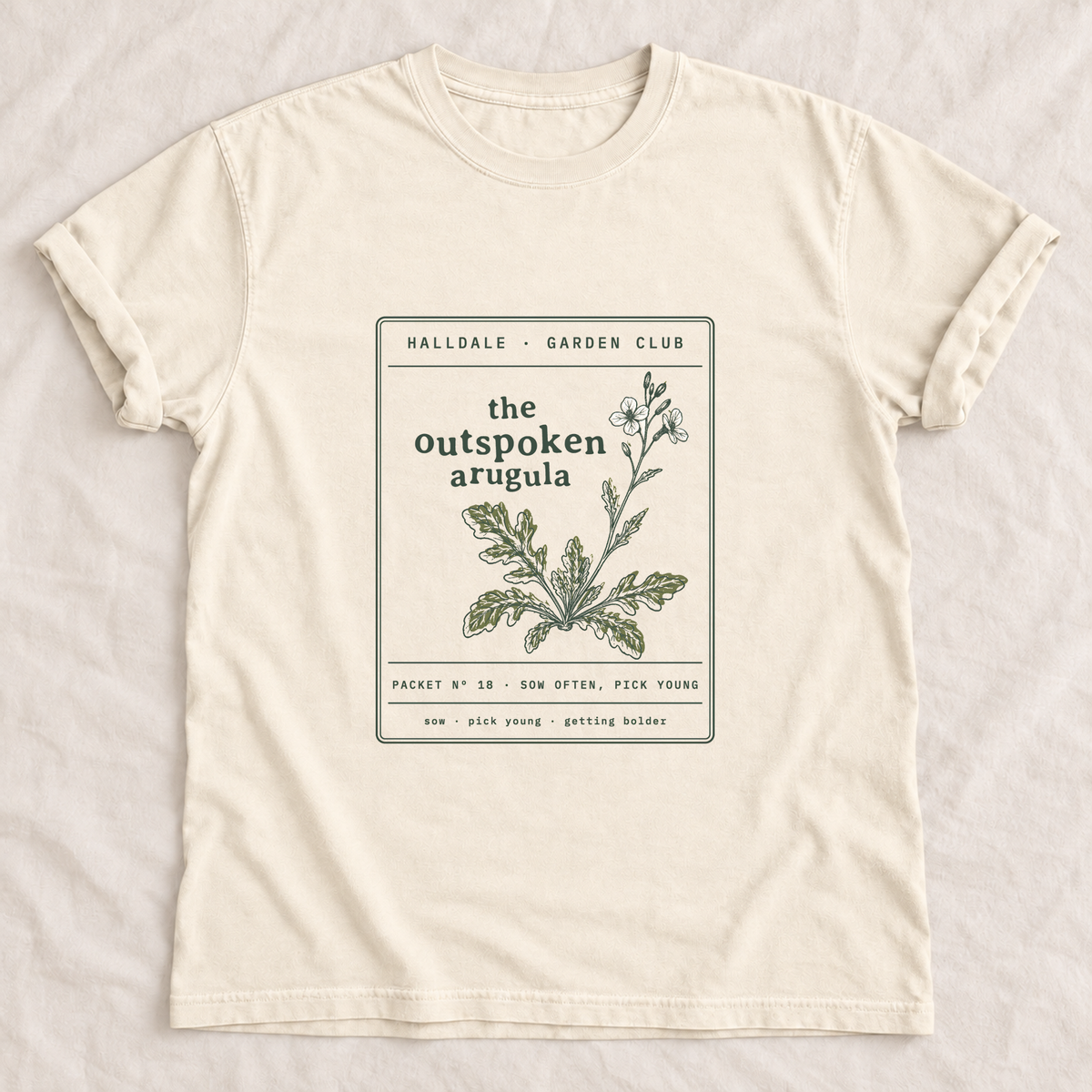 The Outspoken Arugula tee in Ivory, laid flat
