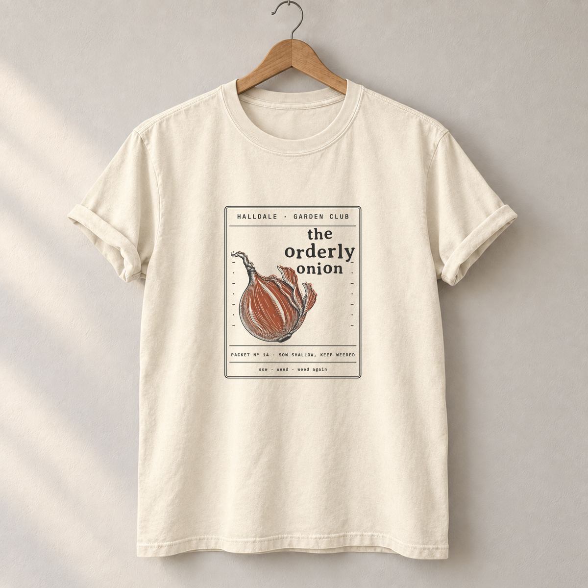 The Orderly Onion tee in Ivory, on a hanger