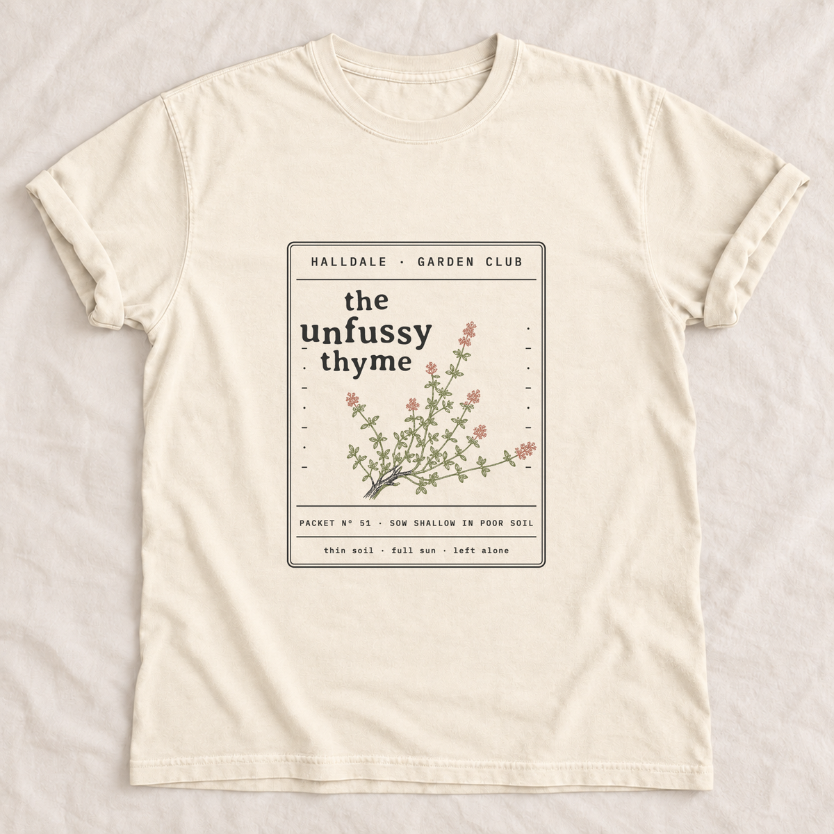 The Unfussy Thyme tee in Ivory, laid flat