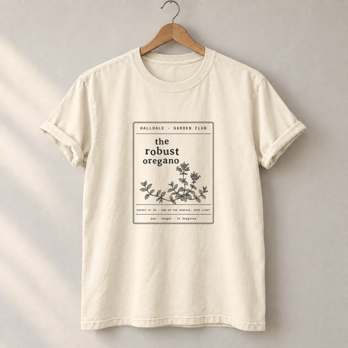 The Robust Oregano tee in Ivory, on a hanger