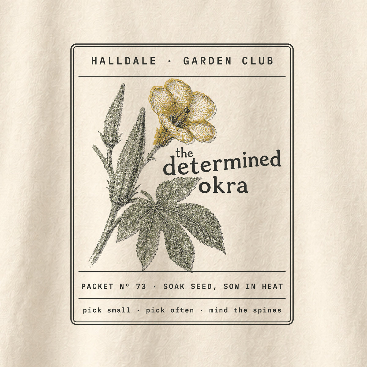 The Determined Okra tee in Ivory, close-up of the print