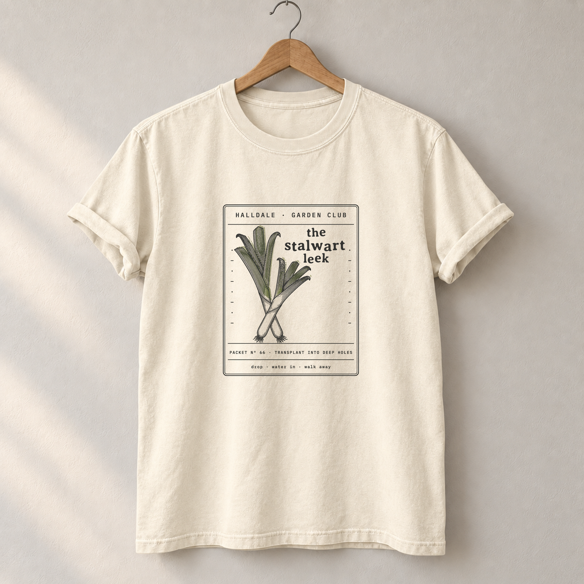 The Stalwart Leek tee in Ivory, on a hanger