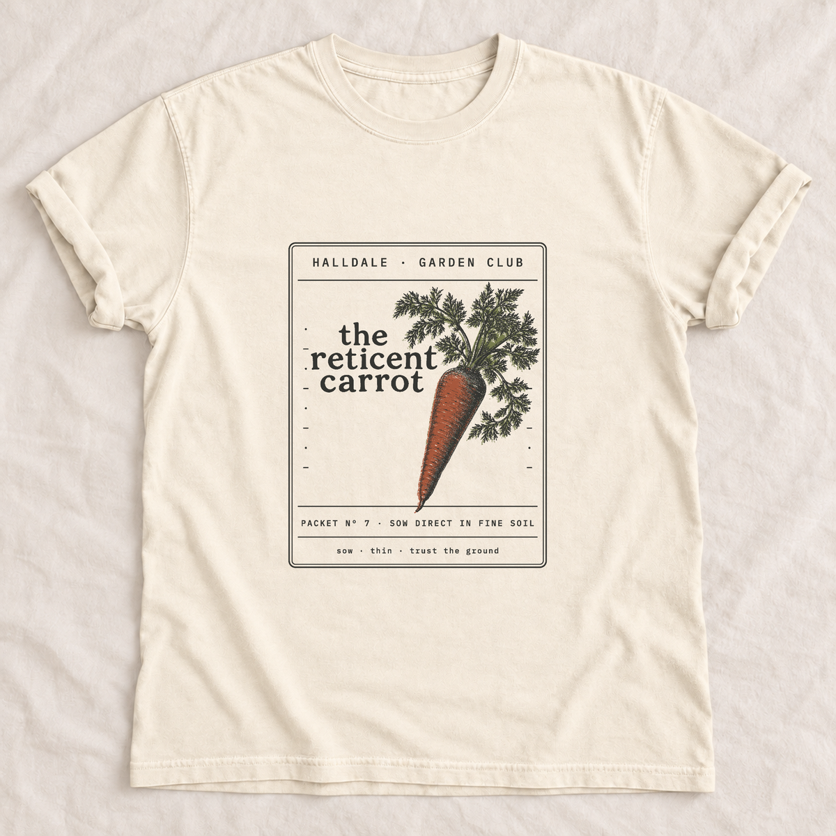 The Reticent Carrot tee in Ivory, laid flat