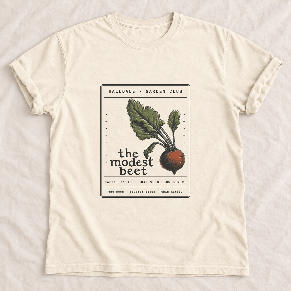 The Modest Beet tee in Ivory, laid flat