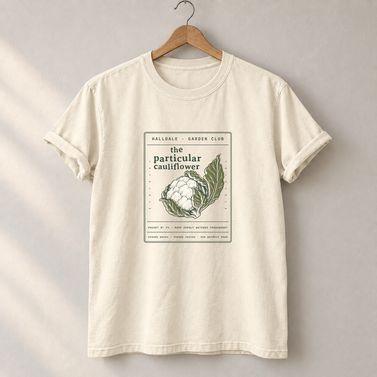 The Particular Cauliflower tee in Ivory, on a hanger