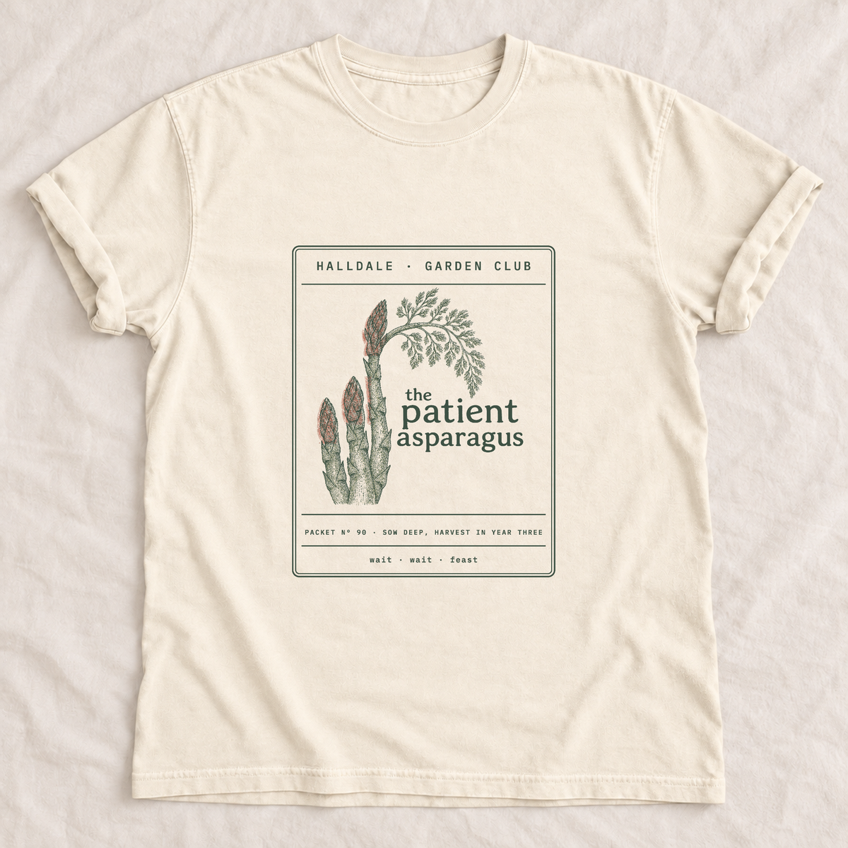 The Patient Asparagus tee in Ivory, laid flat