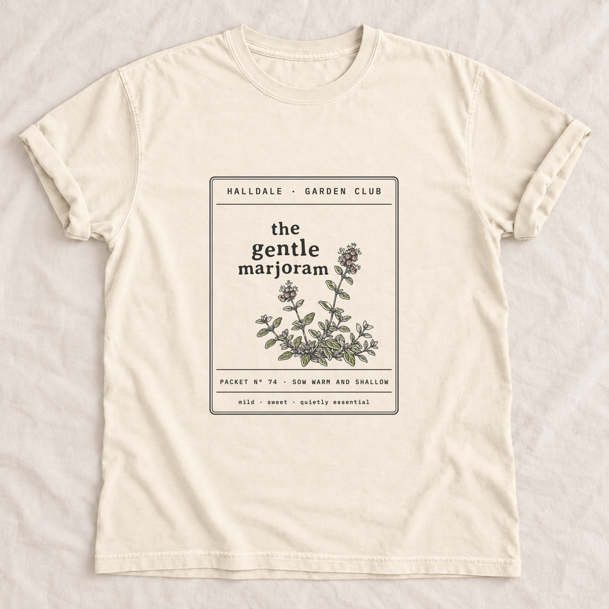 The Gentle Marjoram tee in Ivory, laid flat