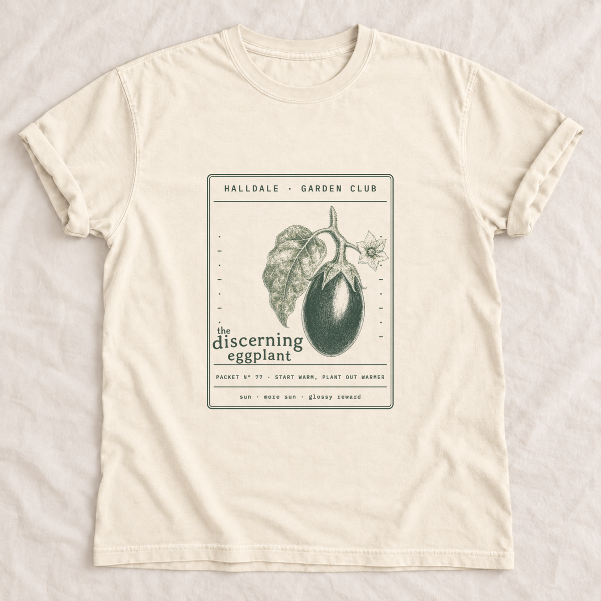 The Discerning Eggplant tee in Ivory, laid flat