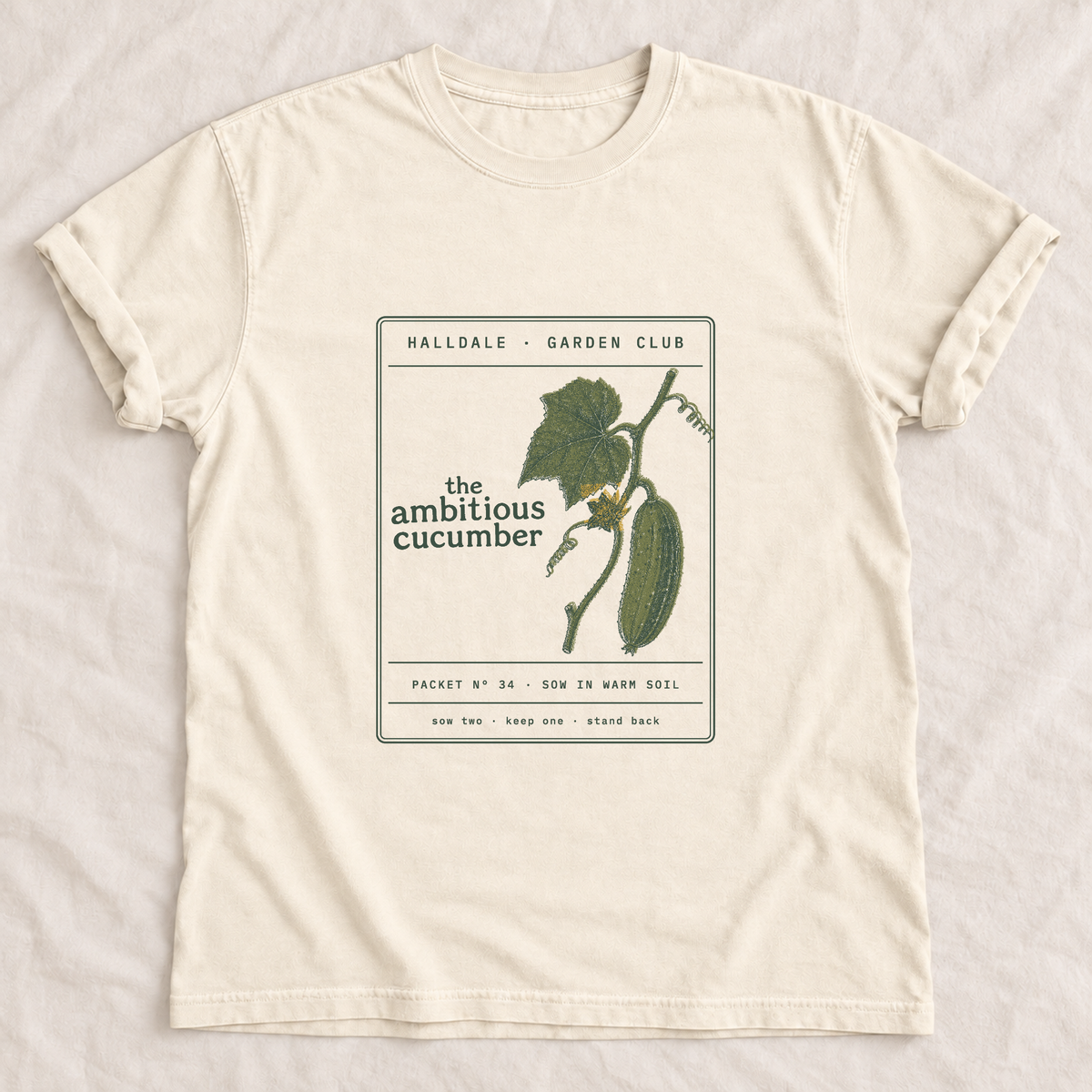 The Ambitious Cucumber tee in Ivory, laid flat