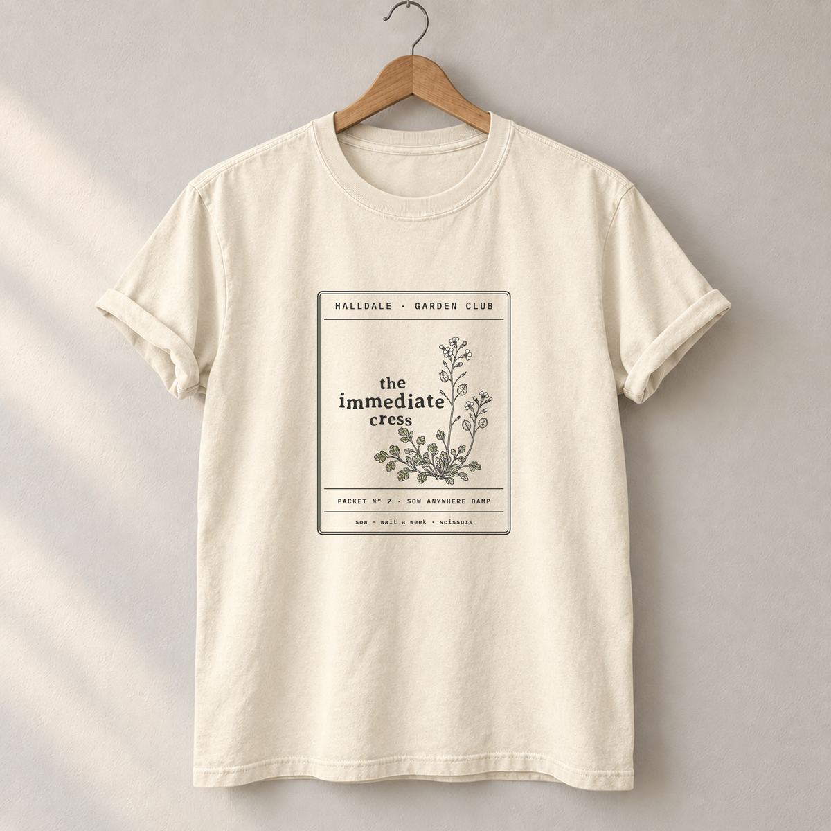 The Immediate Cress tee in Ivory, on a hanger