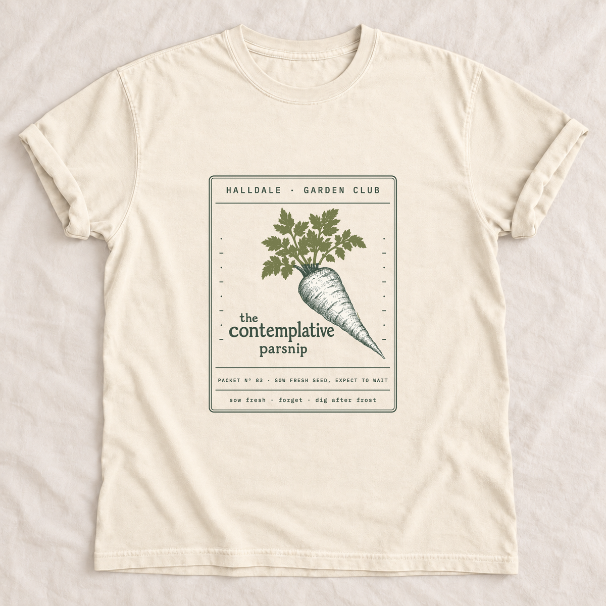 The Contemplative Parsnip tee in Ivory, laid flat