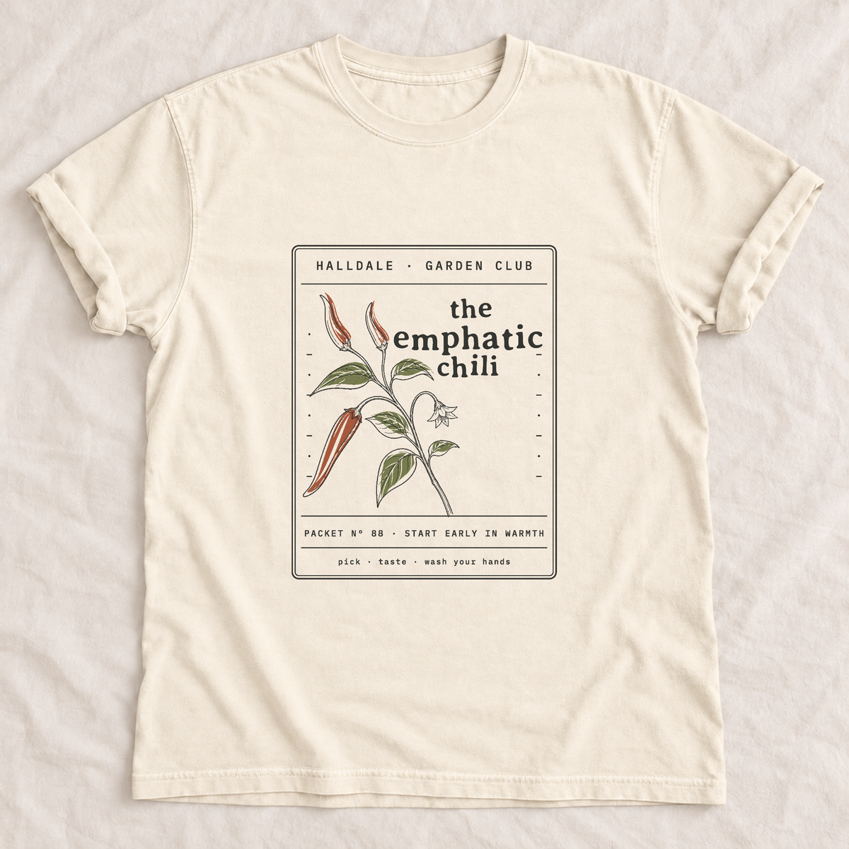 The Emphatic Chili tee in Ivory, laid flat